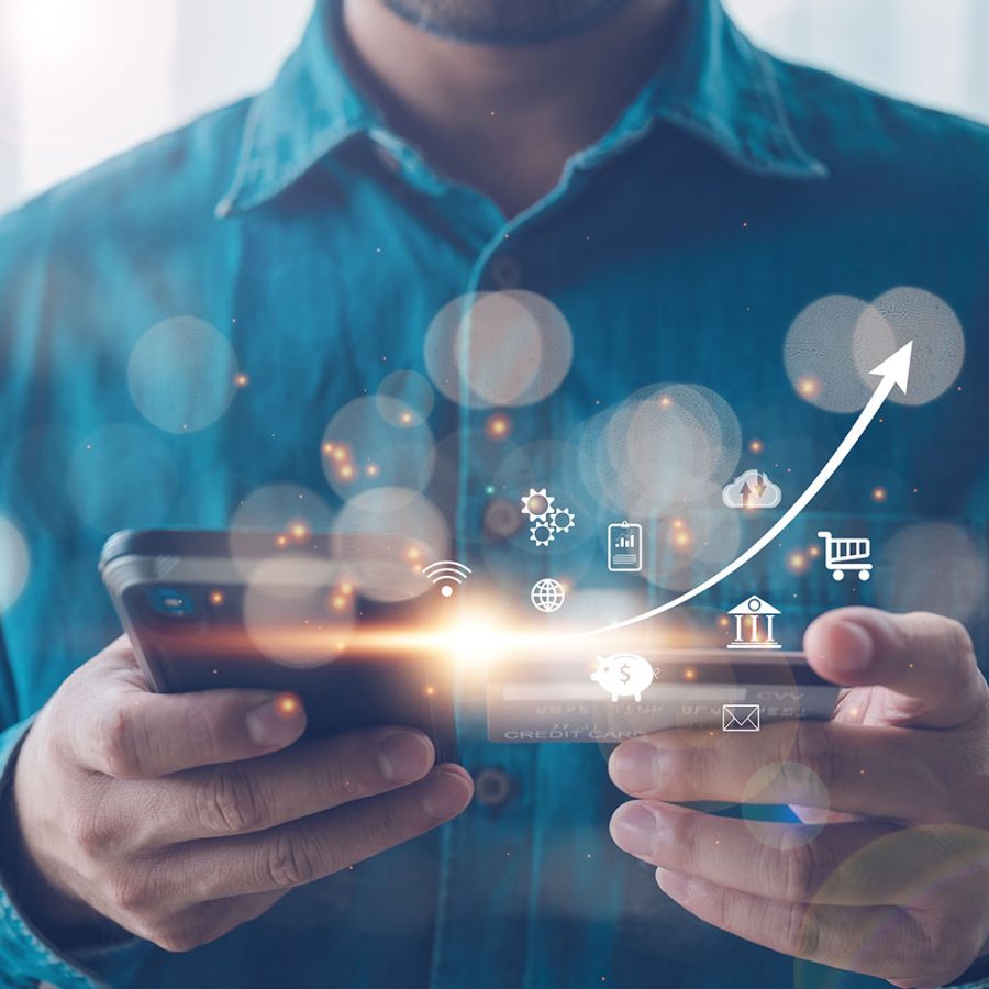 A man using a smartphone with glowing icons representing different digital services