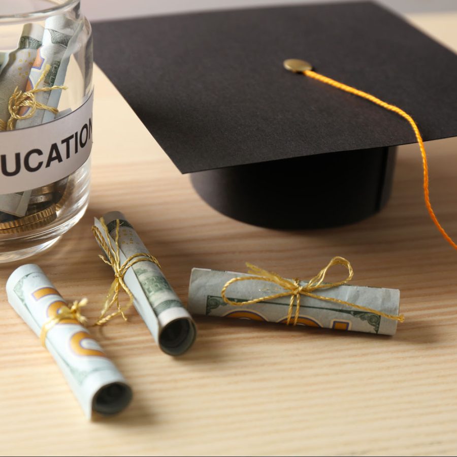 A graduation cap and money symbolizing the cost and value of education.